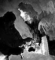 Cavern under sea ice sparkles in lantern light.