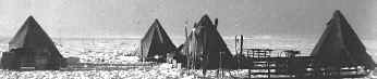 Four tents on the vast polar plateau.